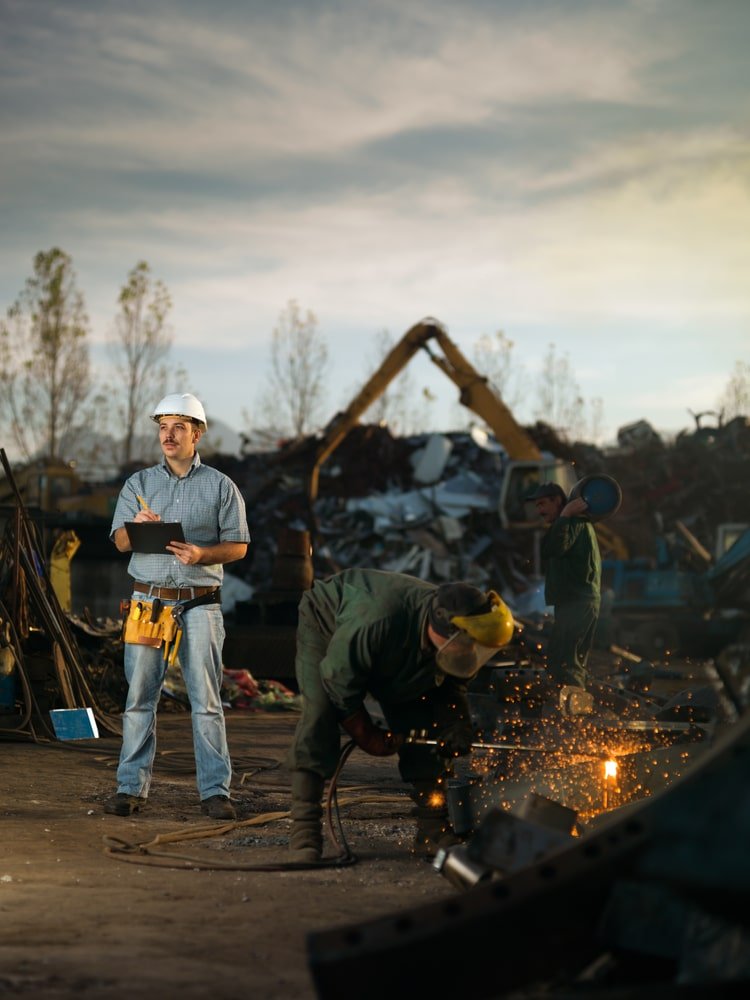 Caucasian,Engineer,Standing,At,Scrap,Metal,Recycling,Site,,Inspecting,Work